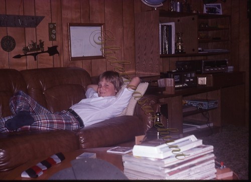 Kid relaxing couch basement - relaxing,